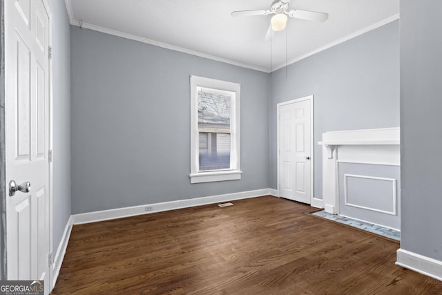 spare room with crown molding, ceiling fan, and dark hardwood / wood-style floors