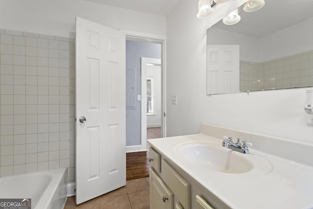 bathroom featuring vanity, tile patterned floors, and tiled shower / bath