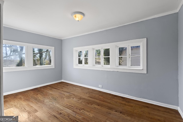 unfurnished room with crown molding and hardwood / wood-style floors