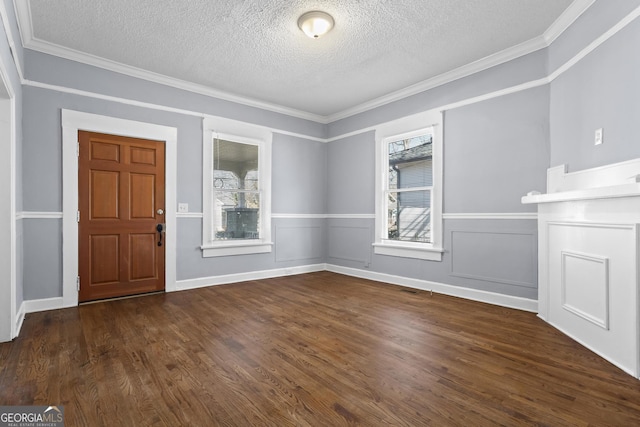 foyer entrance featuring crown molding, dark wood-type flooring, and a textured ceiling