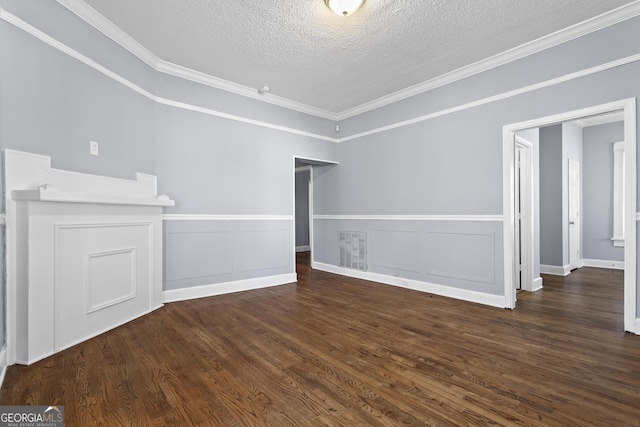 unfurnished living room featuring dark wood-type flooring, ornamental molding, and a textured ceiling