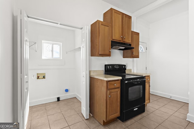 kitchen featuring black range with electric stovetop and light tile patterned floors