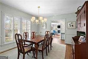 dining space with a notable chandelier and light wood-type flooring