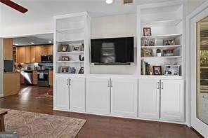 bar featuring white cabinetry, built in shelves, dark wood-type flooring, and ceiling fan