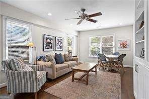 living room featuring dark hardwood / wood-style floors and ceiling fan