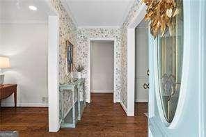 hall featuring ornamental molding and dark hardwood / wood-style flooring