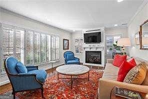 living room with ornamental molding and wood-type flooring