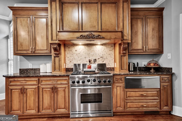 kitchen featuring ornamental molding, stainless steel range, and dark stone counters