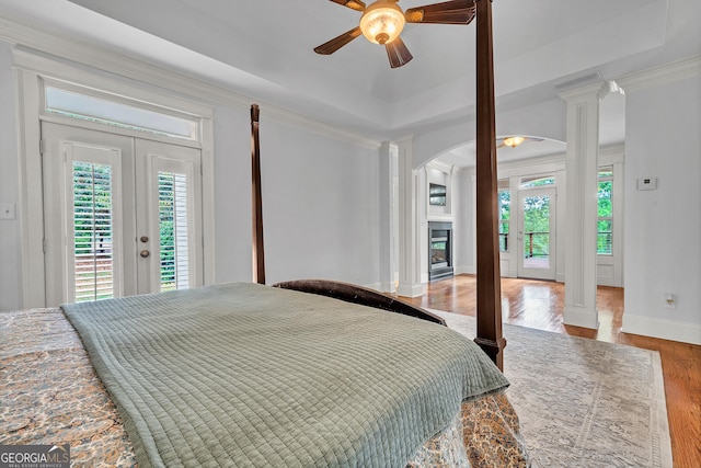 bedroom featuring access to exterior, ceiling fan, and ornate columns