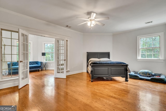 bedroom featuring multiple windows, french doors, and ceiling fan