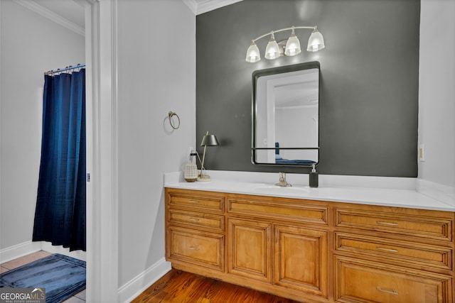 bathroom with crown molding, vanity, curtained shower, and hardwood / wood-style floors