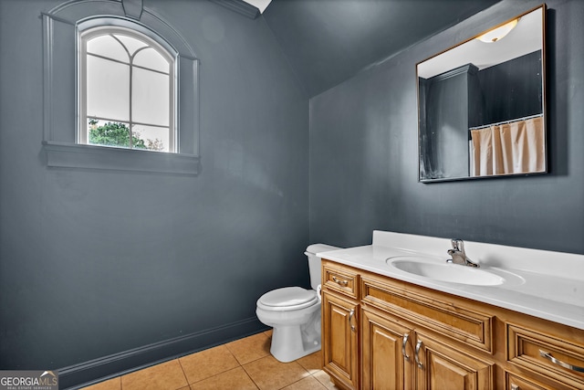 bathroom featuring tile patterned flooring, vanity, and toilet