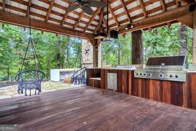 wooden terrace featuring a bar, area for grilling, exterior kitchen, ceiling fan, and a gazebo