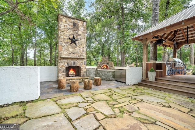 view of patio featuring an outdoor stone fireplace