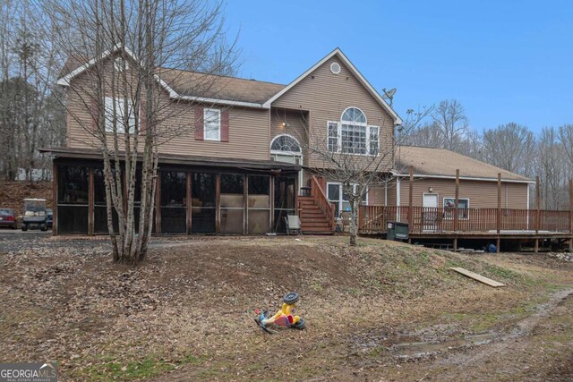 view of front of home featuring a sunroom and a deck