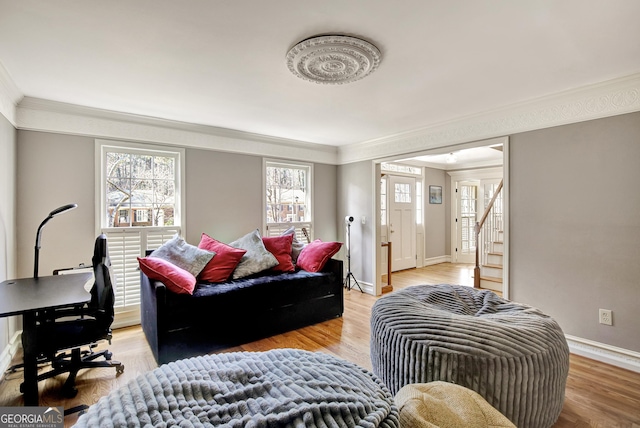 living room with hardwood / wood-style flooring and ornamental molding