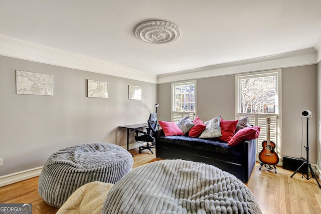 living room with crown molding and light wood-type flooring