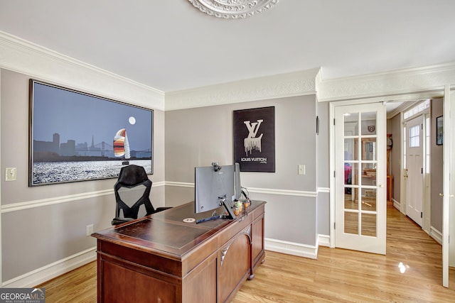 office with light hardwood / wood-style flooring and ornamental molding