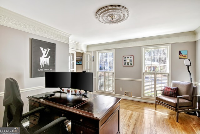 home office with ornamental molding, a wealth of natural light, and light hardwood / wood-style flooring