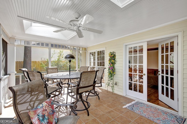 sunroom featuring a skylight, french doors, and ceiling fan