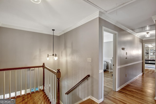 stairway featuring hardwood / wood-style flooring and ornamental molding