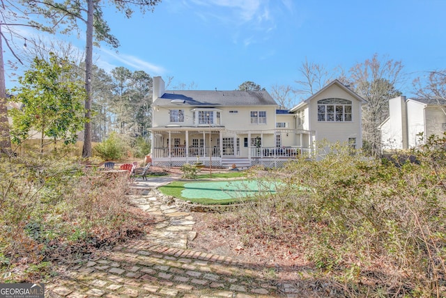 back of house featuring covered porch