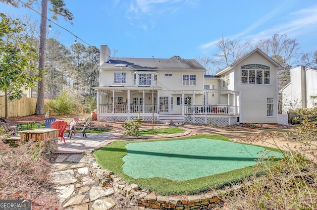 rear view of property with a balcony and a patio area