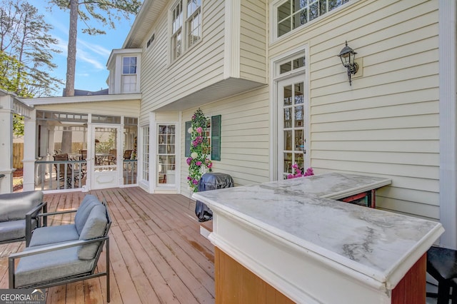 wooden deck featuring a sunroom