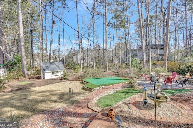 exterior space featuring a storage unit, an outdoor fire pit, and a patio