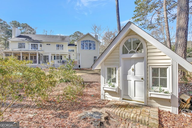 rear view of property with an outbuilding