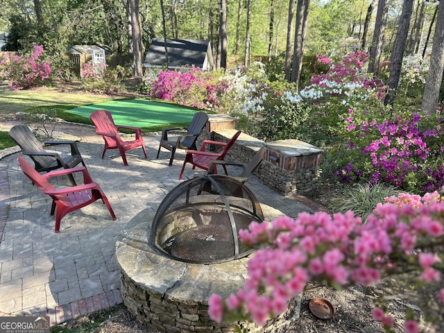 view of patio with a fire pit