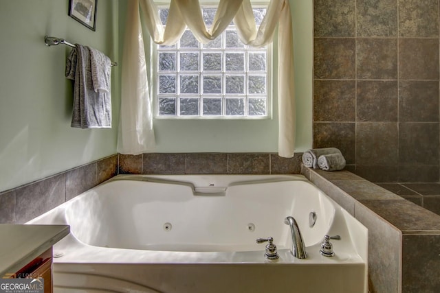 bathroom featuring vanity and a tub