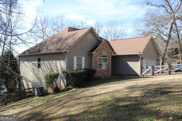 view of side of property with a yard and a garage