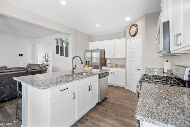 kitchen featuring a kitchen island with sink, sink, white cabinetry, and appliances with stainless steel finishes