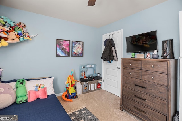 carpeted bedroom with ceiling fan and a closet