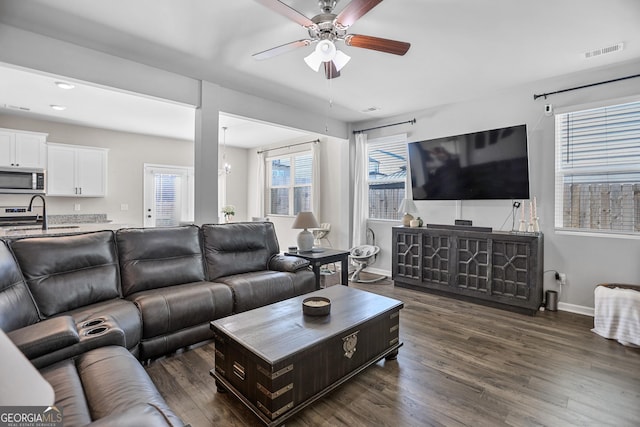 living room featuring sink, ceiling fan with notable chandelier, and dark hardwood / wood-style floors