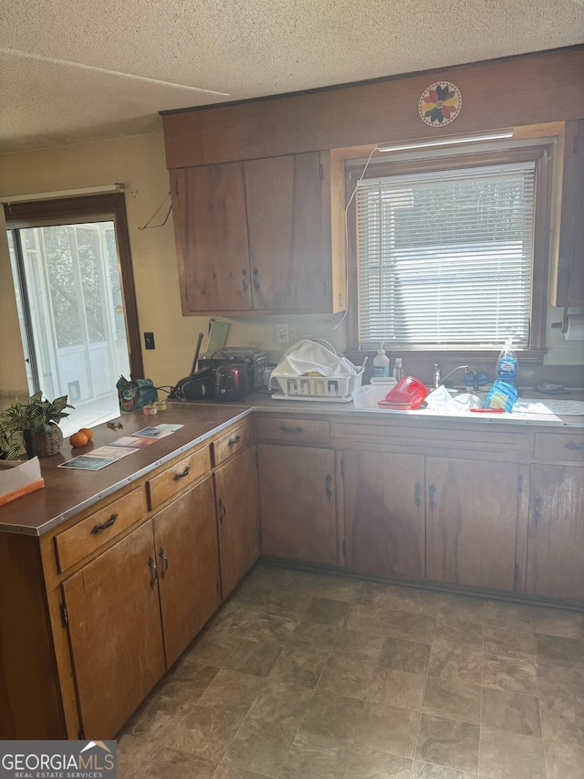 kitchen featuring plenty of natural light and a textured ceiling