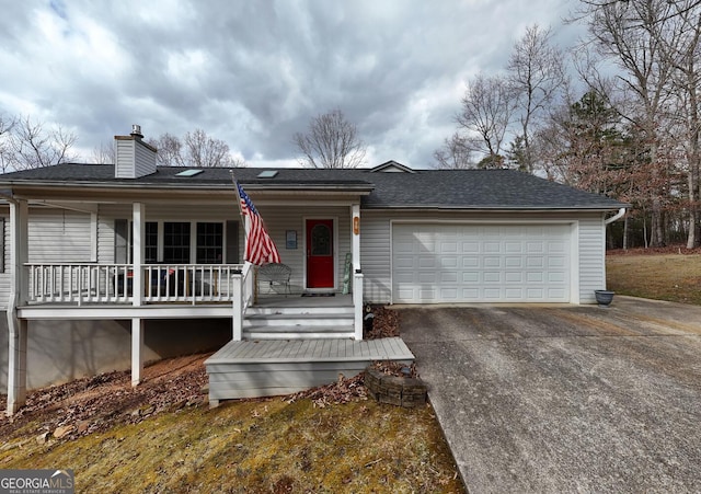 single story home featuring a garage and covered porch