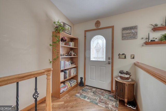 foyer entrance with light hardwood / wood-style floors