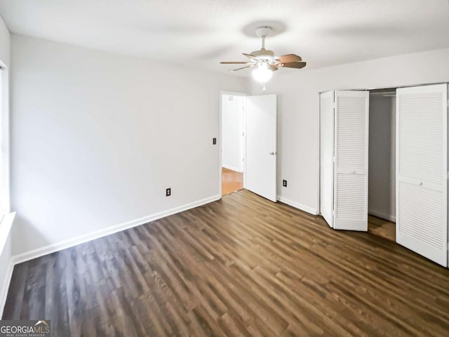 unfurnished bedroom featuring dark wood-type flooring and ceiling fan