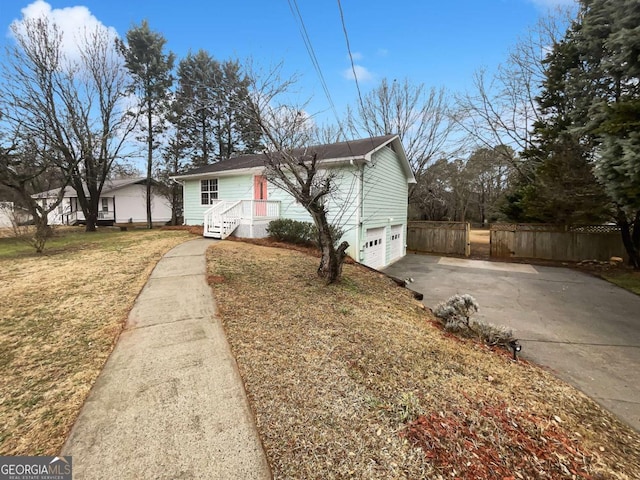 view of front of property with a garage and a front lawn