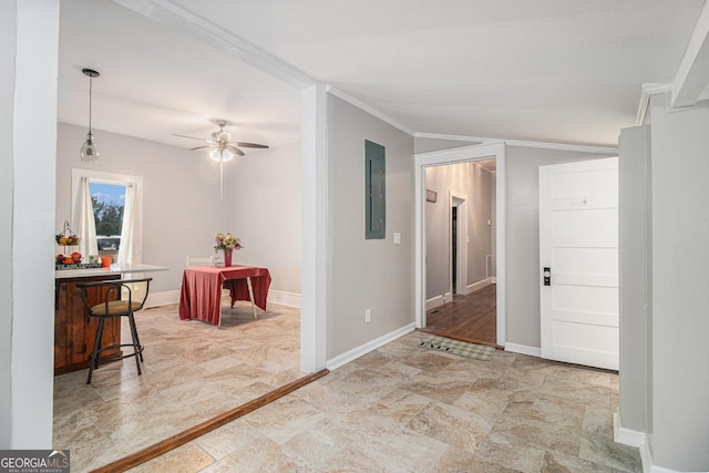 entrance foyer featuring ceiling fan, ornamental molding, and electric panel