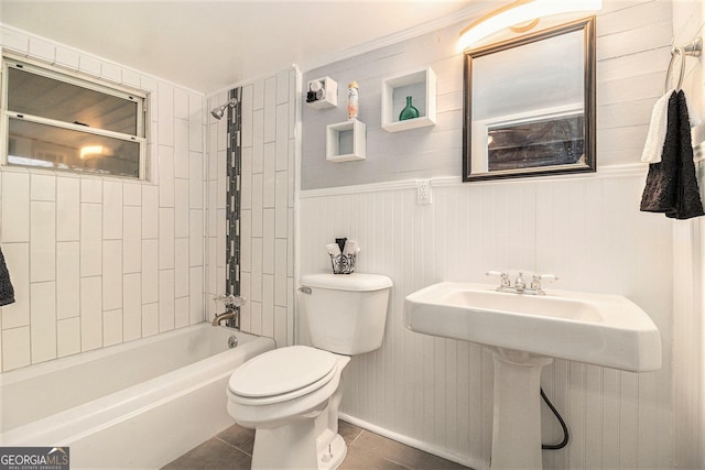 full bathroom featuring tile patterned flooring, tiled shower / bath, sink, and toilet