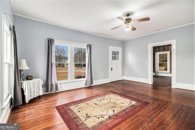 living room featuring crown molding, dark wood-type flooring, and ceiling fan