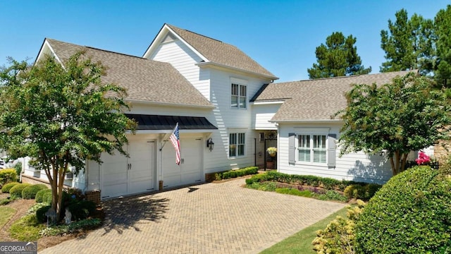 back of property with a garage