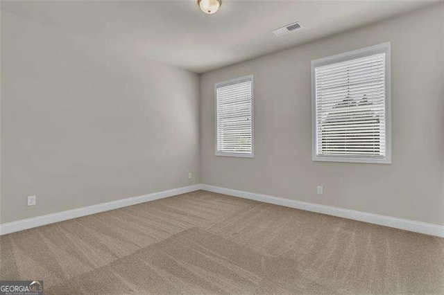 empty room with light colored carpet