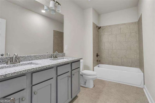 full bathroom featuring vanity, toilet, and tiled shower / bath