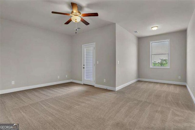 empty room with ceiling fan and light colored carpet