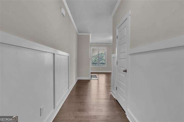 hall featuring crown molding and dark hardwood / wood-style flooring