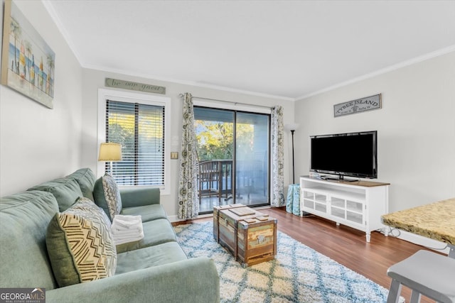 living room with crown molding and hardwood / wood-style floors